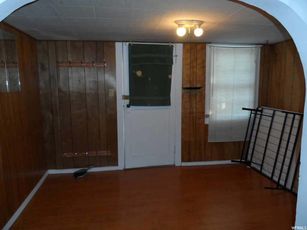 Interior space featuring wood walls and hardwood / wood-style floors