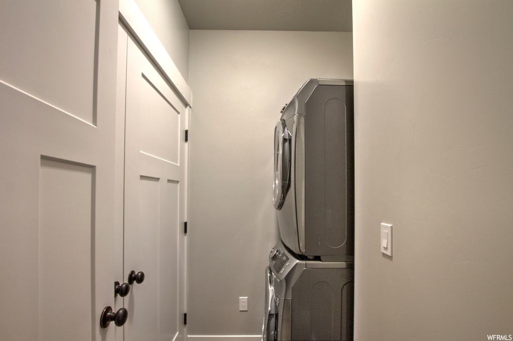 Laundry room featuring stacked washer / drying machine