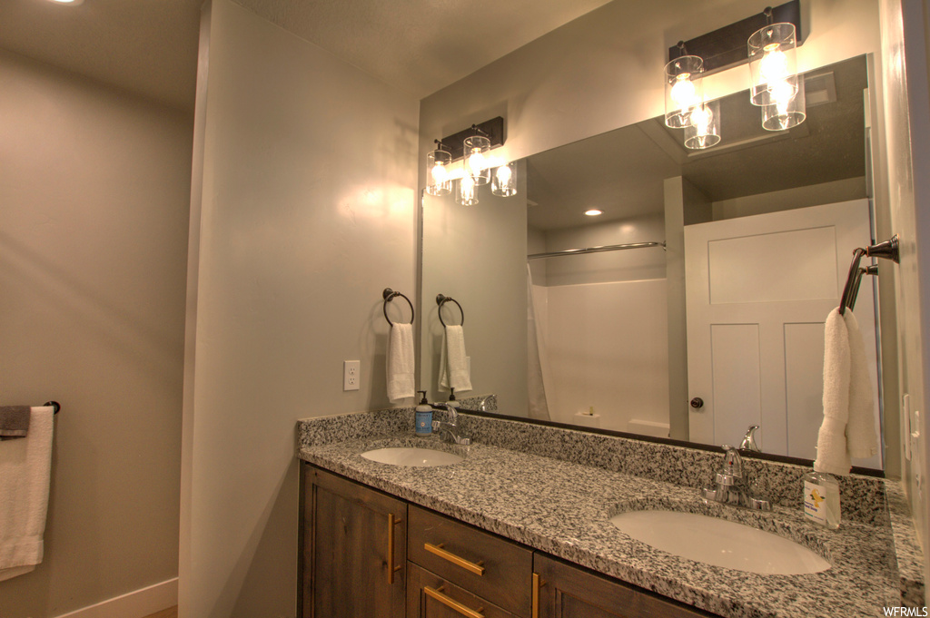 Bathroom with vanity with extensive cabinet space and dual sinks