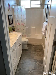 Full bathroom with vanity, toilet, tile floors, and shower / bath combo