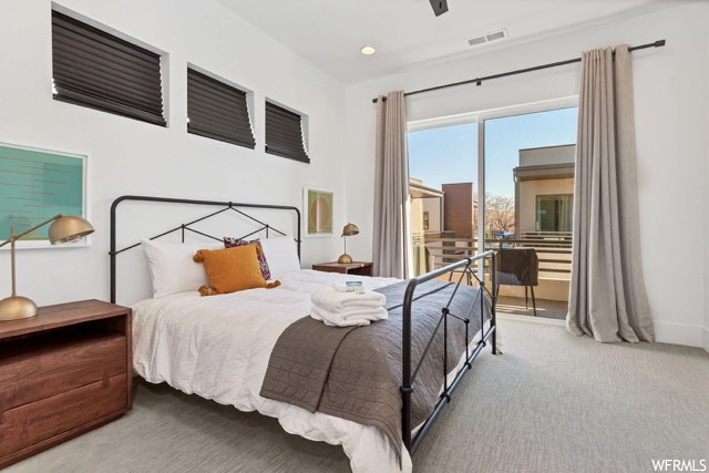 Bedroom featuring light carpet, ceiling fan, and access to exterior