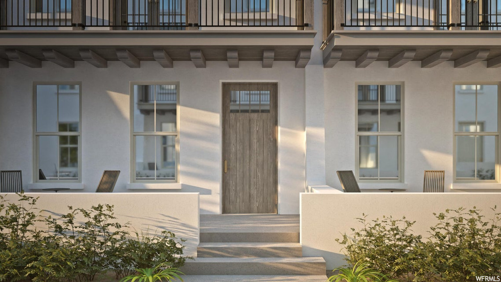 Entrance to property featuring a balcony