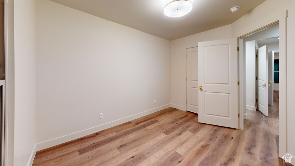 Unfurnished bedroom featuring light wood-type flooring