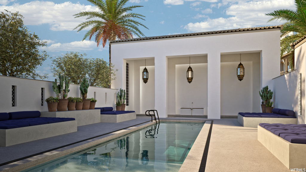 View of pool with a patio and an outdoor hangout area