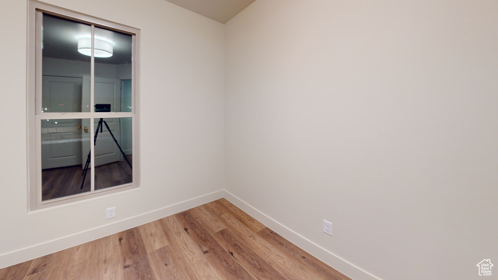 Unfurnished room with hardwood / wood-style flooring