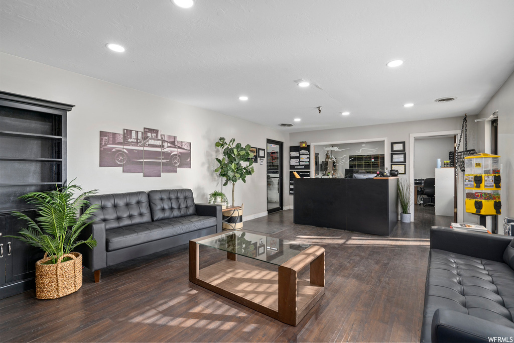 Living room with dark wood-type flooring