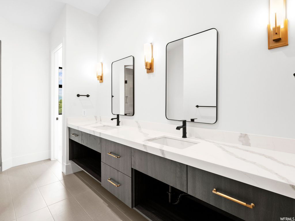 Bathroom featuring tile floors and double sink vanity