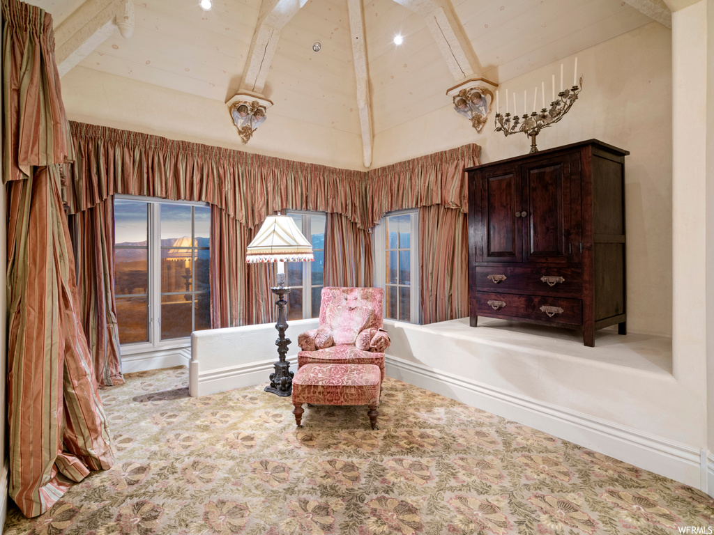 Sitting room featuring beamed ceiling, carpet flooring, and high vaulted ceiling