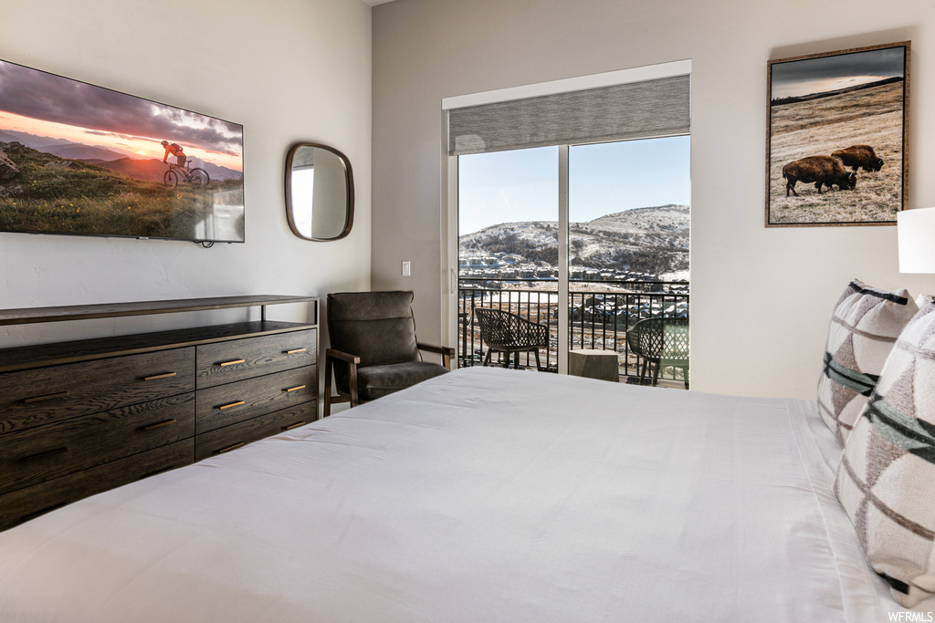 Bedroom featuring access to outside and a mountain view