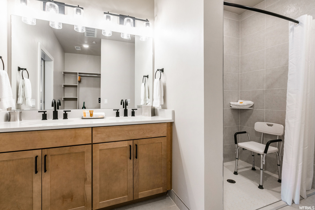 Bathroom with dual vanity and tile floors