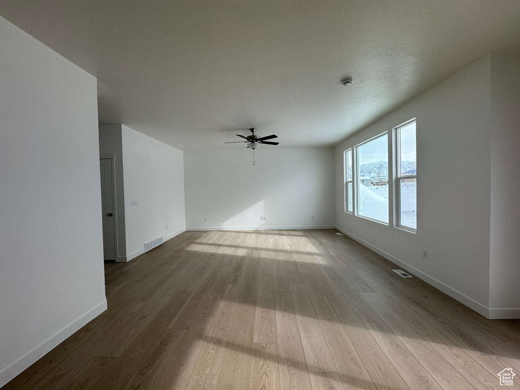 Spare room featuring hardwood / wood-style flooring and ceiling fan