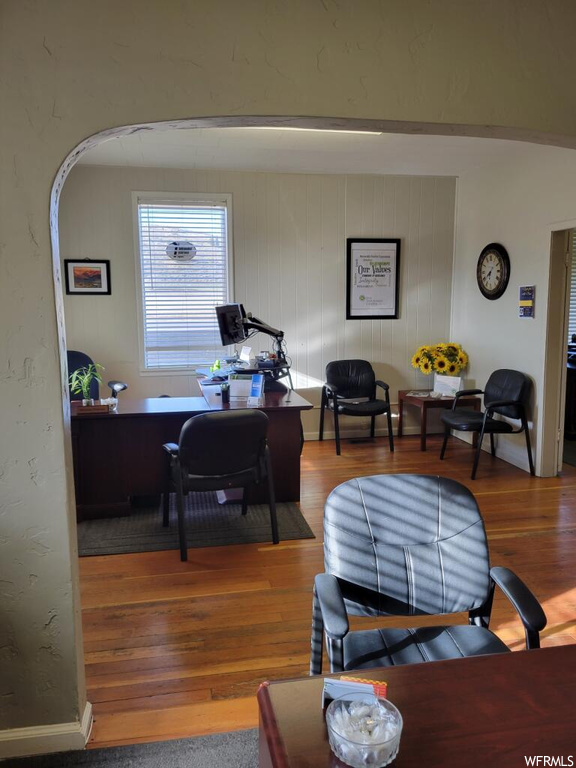 Office space with hardwood / wood-style flooring