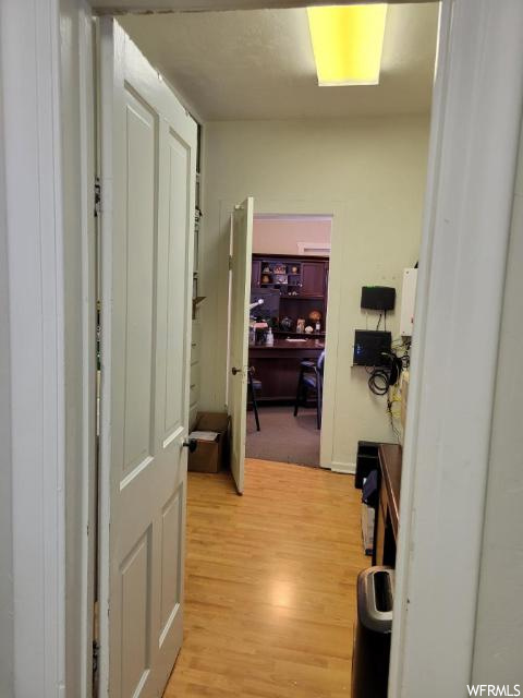 Hallway with light hardwood / wood-style floors