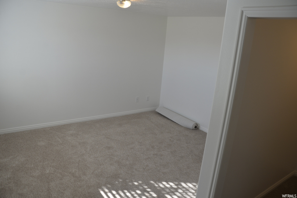 Empty room with carpet flooring