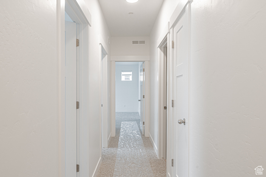 Hall with light colored carpet
