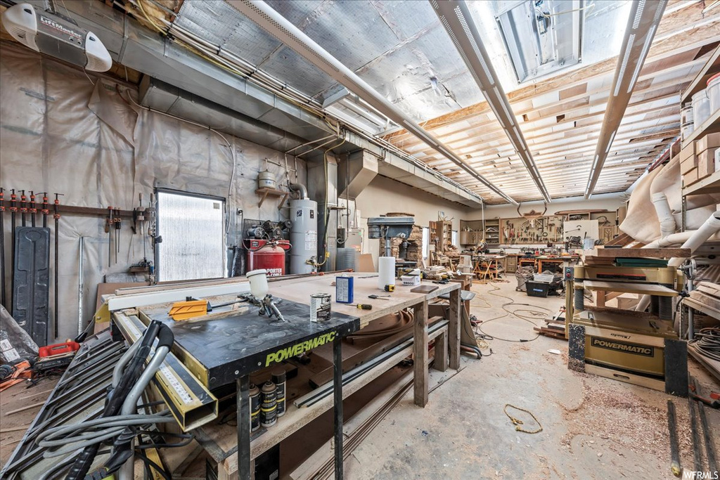 Basement with gas water heater and a workshop area