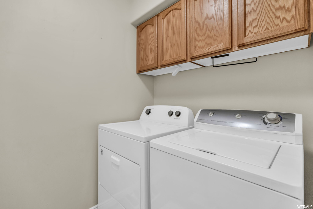 Laundry room with cabinets and washing machine and dryer