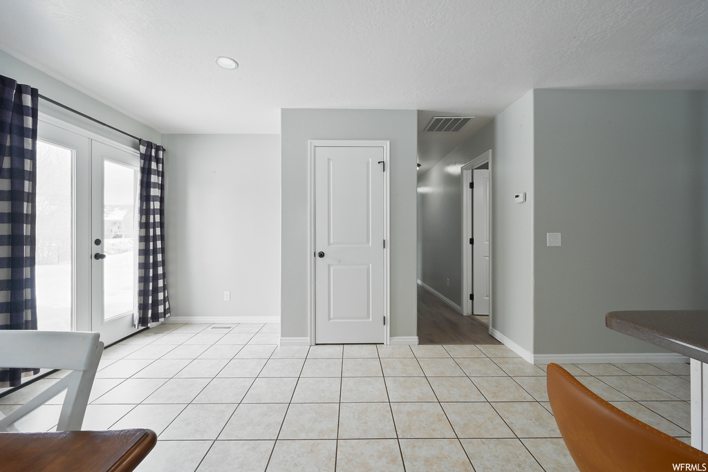 Tiled empty room with french doors