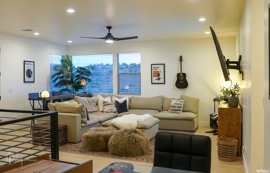 Living room featuring light wood-type flooring and ceiling fan
