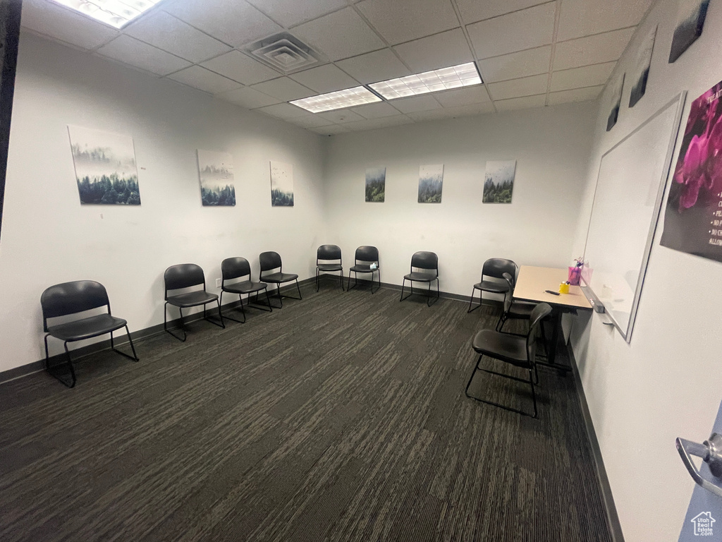 Misc room with carpet flooring and a paneled ceiling