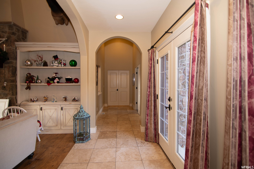 Tiled entrance foyer with french doors