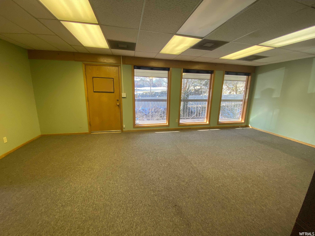 Carpeted empty room with a paneled ceiling