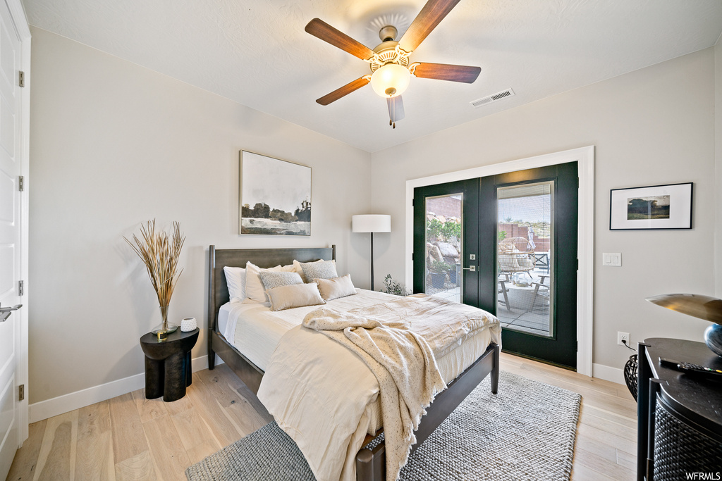 Bedroom with ceiling fan, light wood-type flooring, access to outside, and french doors