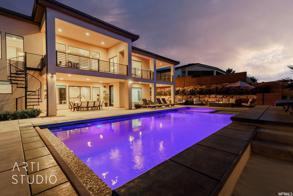 Pool at dusk with a patio