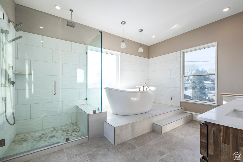 Bathroom featuring vanity and plus walk in shower