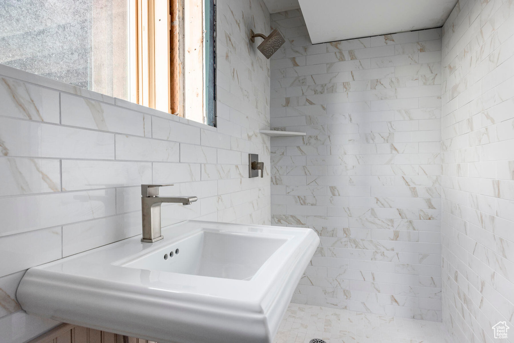 Bathroom with sink and tiled shower