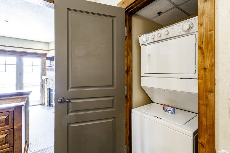 Laundry room with stacked washer and clothes dryer