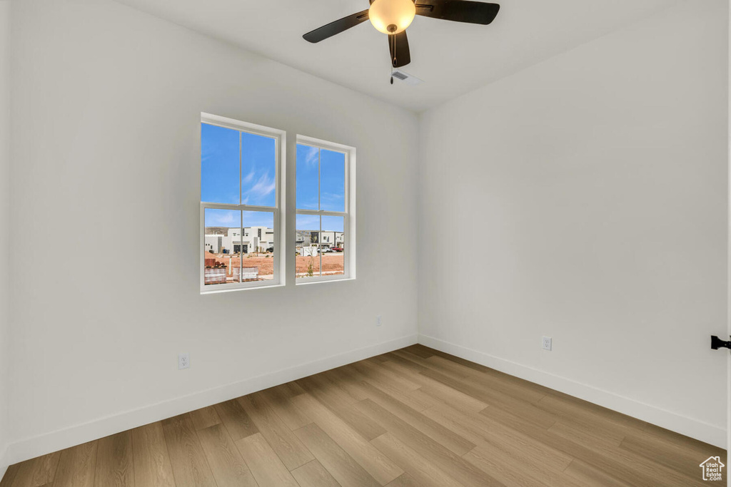 Spare room with ceiling fan and light hardwood / wood-style flooring