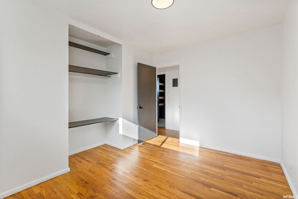 Unfurnished bedroom featuring a closet and light wood-type flooring