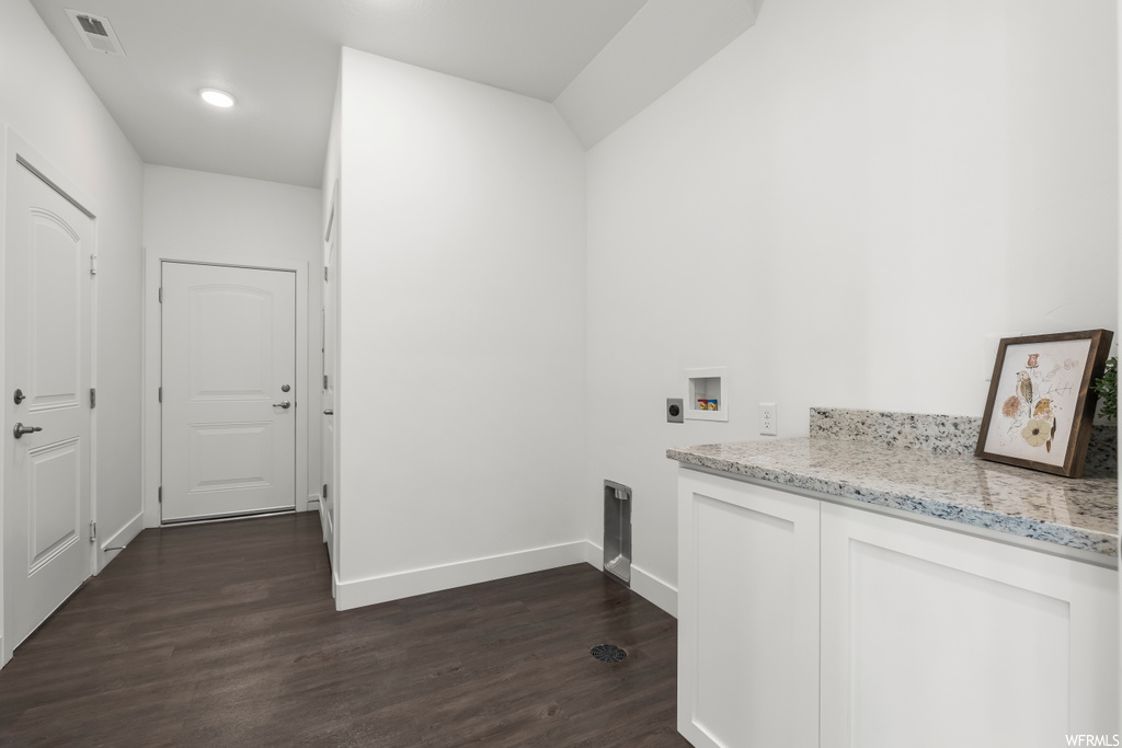 Laundry room with electric dryer hookup, dark hardwood / wood-style flooring, and hookup for a washing machine
