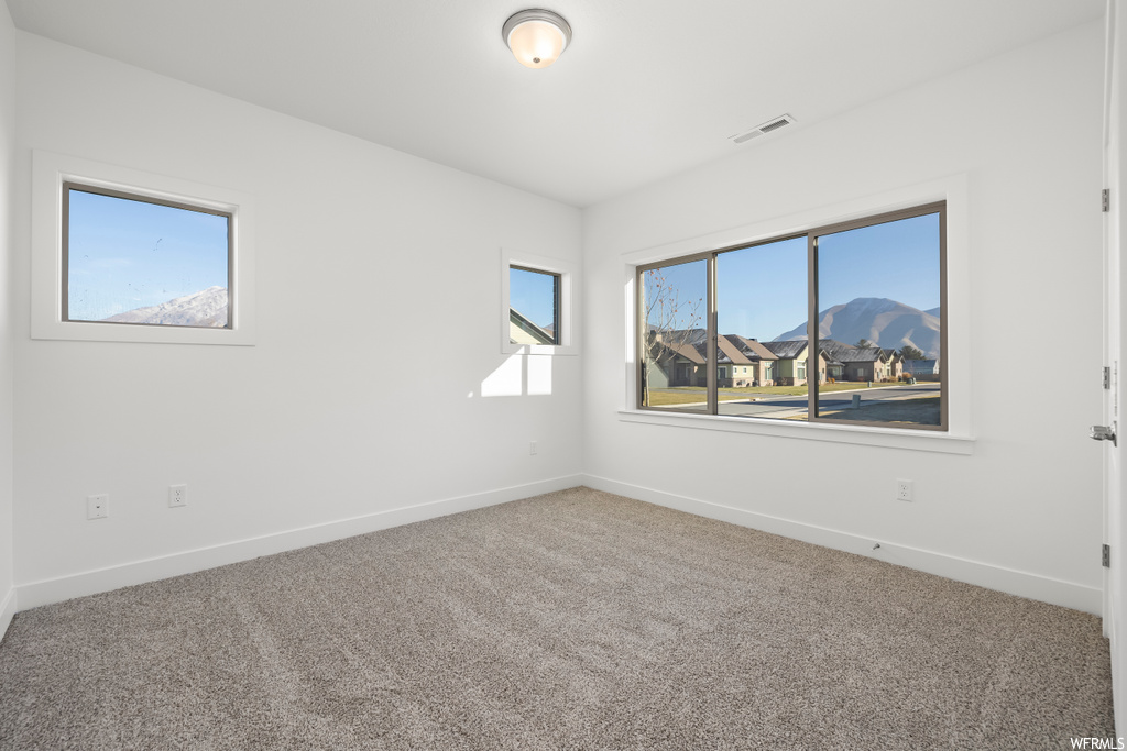 Carpeted empty room with a mountain view