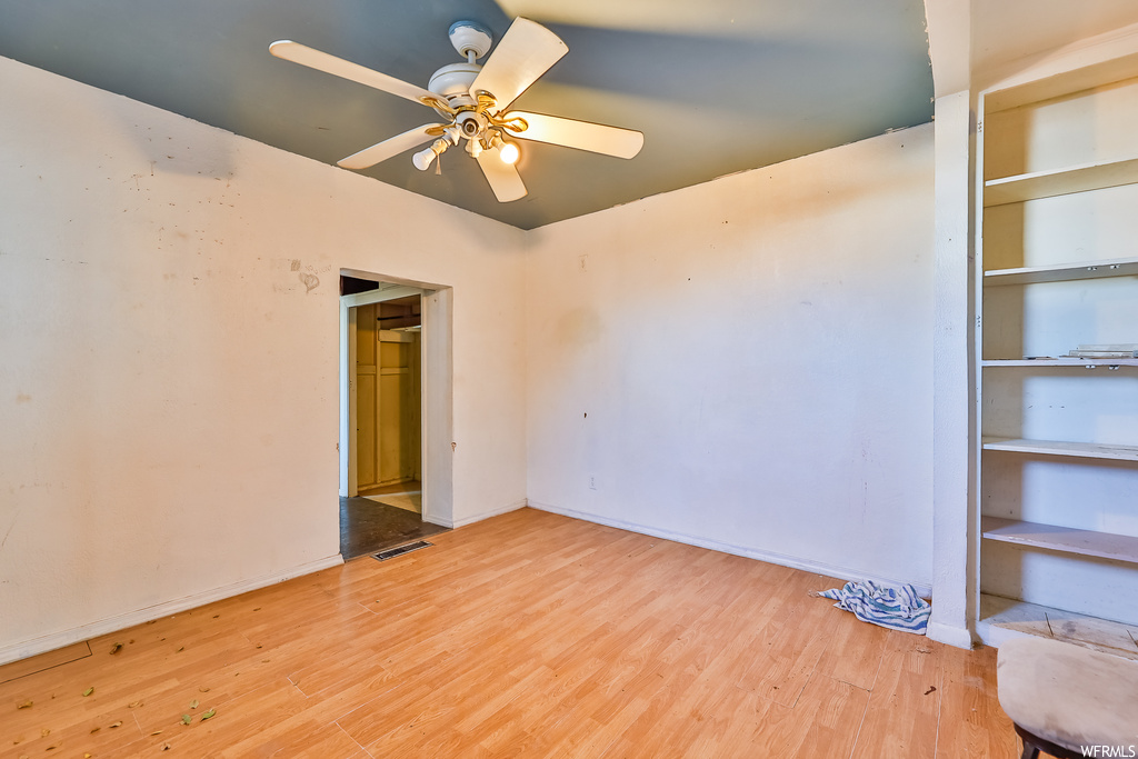 Unfurnished room featuring ceiling fan and light hardwood / wood-style floors