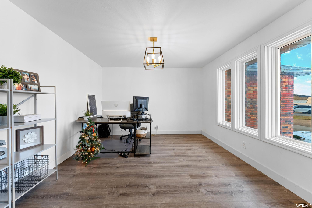Office featuring an inviting chandelier and wood-type flooring