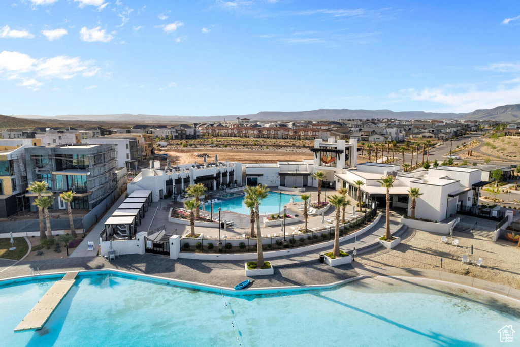 View of pool with a mountain view and a patio