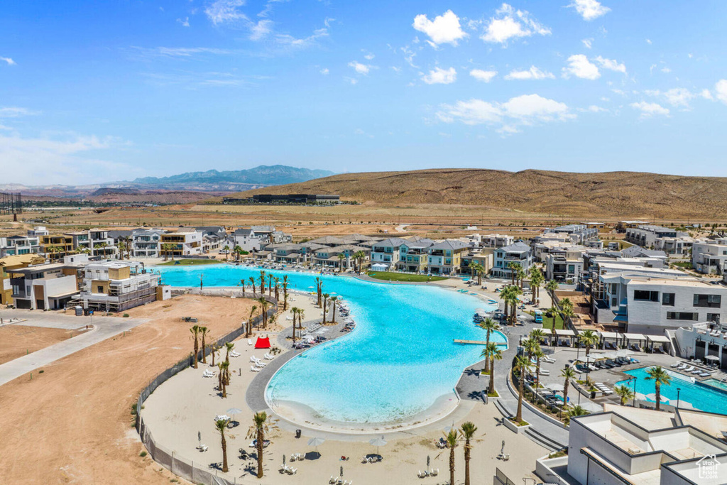 View of pool with a patio and a mountain view