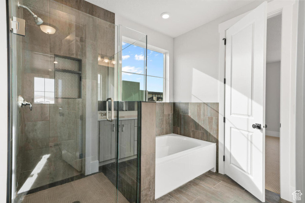 Bathroom featuring tile flooring and separate shower and tub