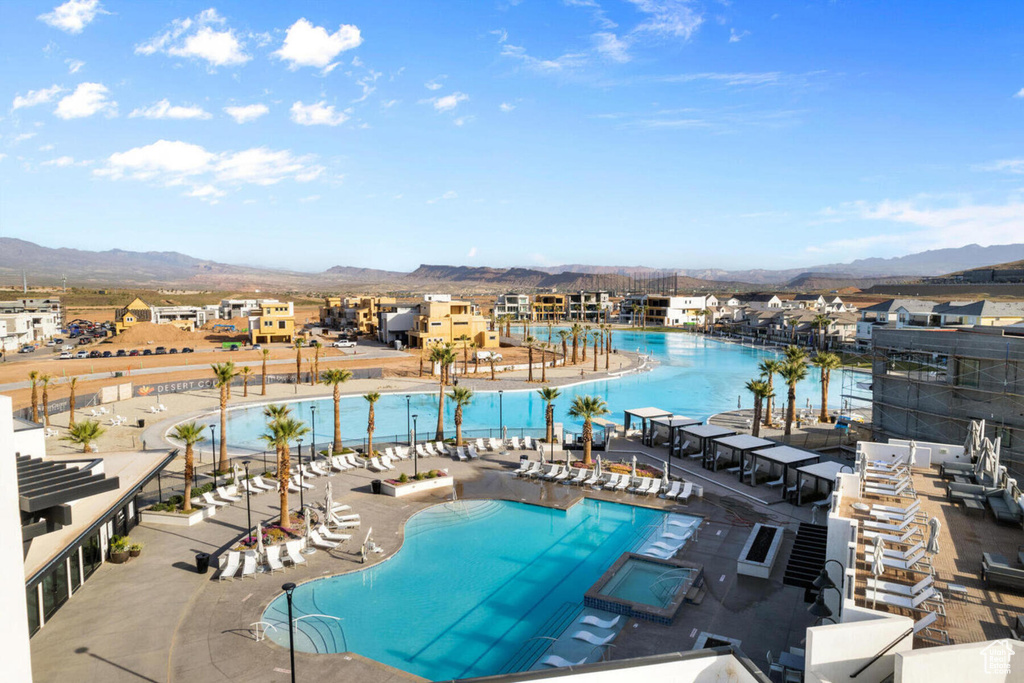 View of swimming pool with a mountain view and a patio area