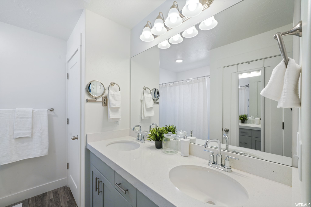 Bathroom featuring hardwood / wood-style floors and double sink vanity