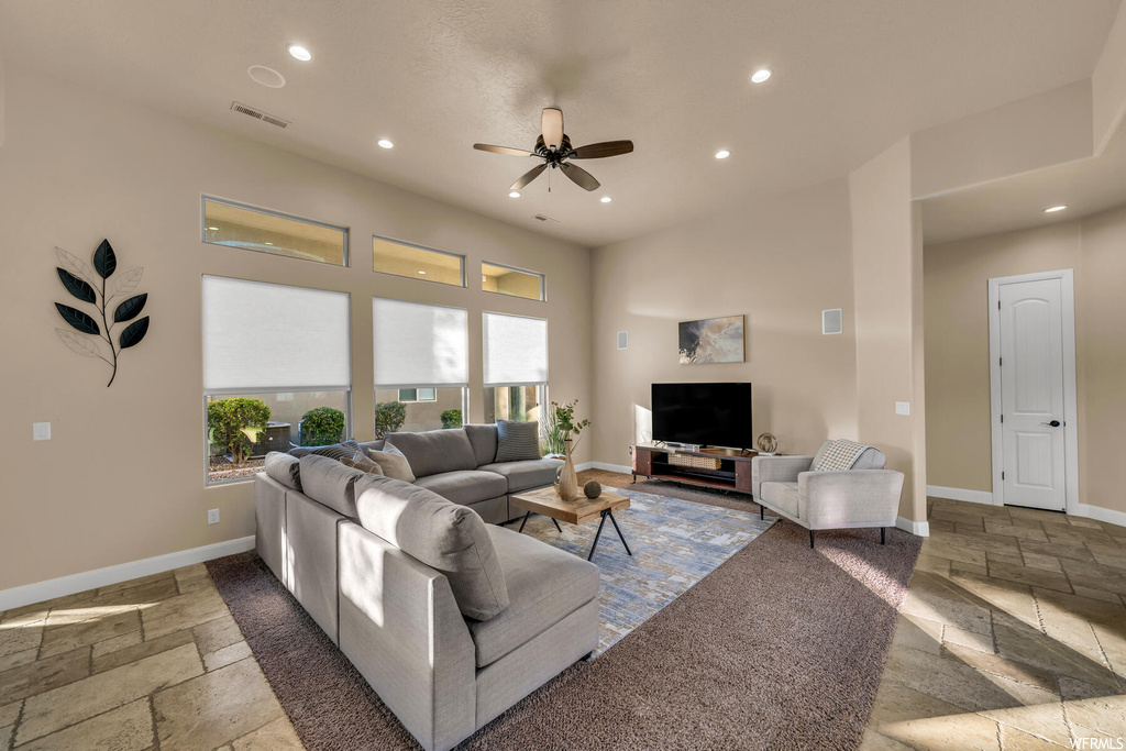 Living room featuring ceiling fan and tile flooring
