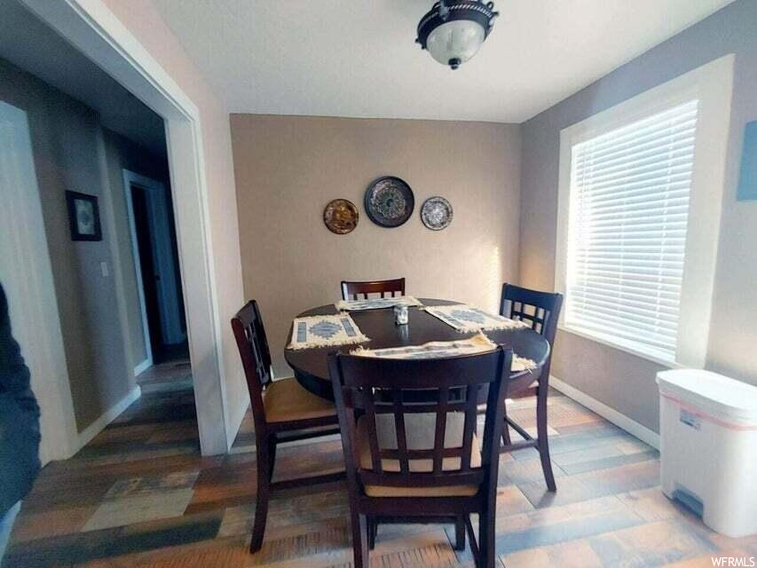 Dining area with light hardwood / wood-style flooring