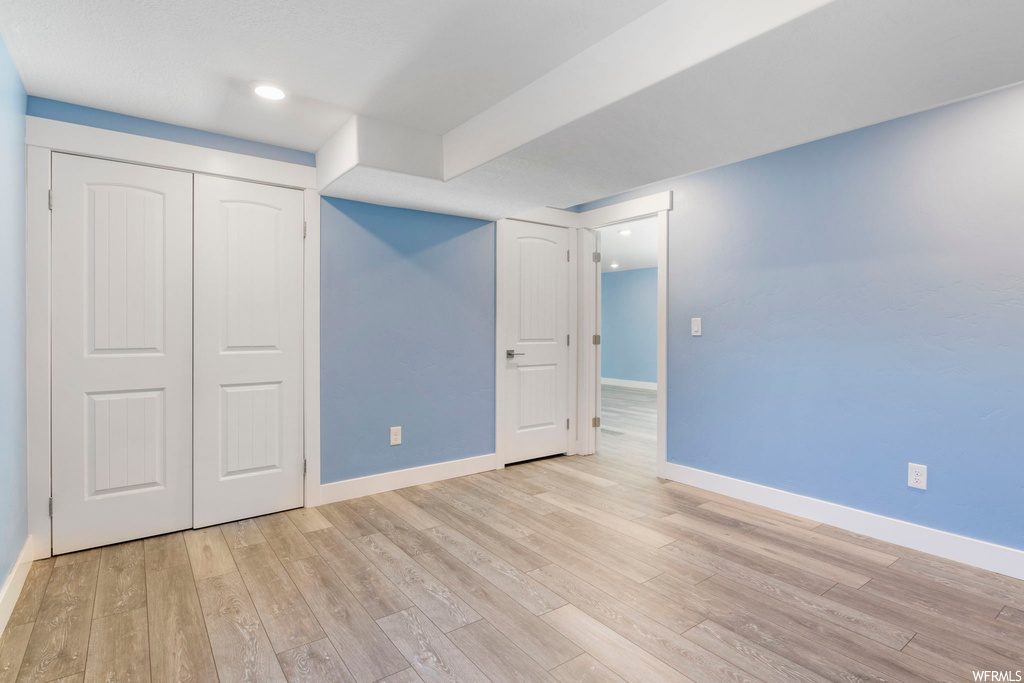 Unfurnished bedroom featuring light hardwood / wood-style flooring and a closet