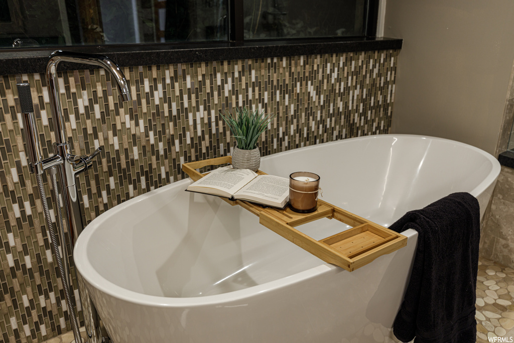 Details with tile flooring and a bath to relax in