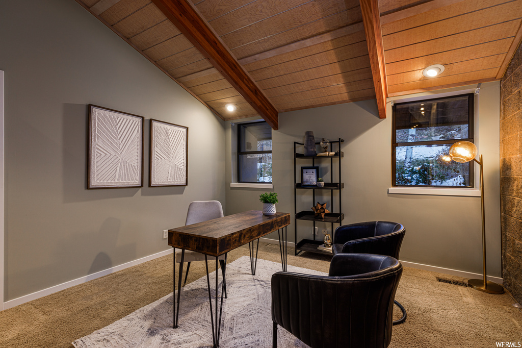 Office space featuring light colored carpet, lofted ceiling with beams, and wooden ceiling