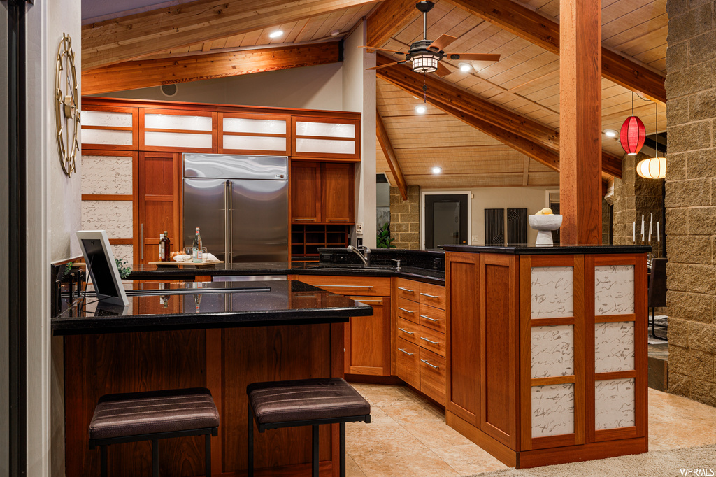 Kitchen featuring wood ceiling, high end refrigerator, and ceiling fan