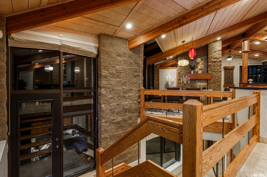 Wine cellar with vaulted ceiling with beams, wooden ceiling, and bar area
