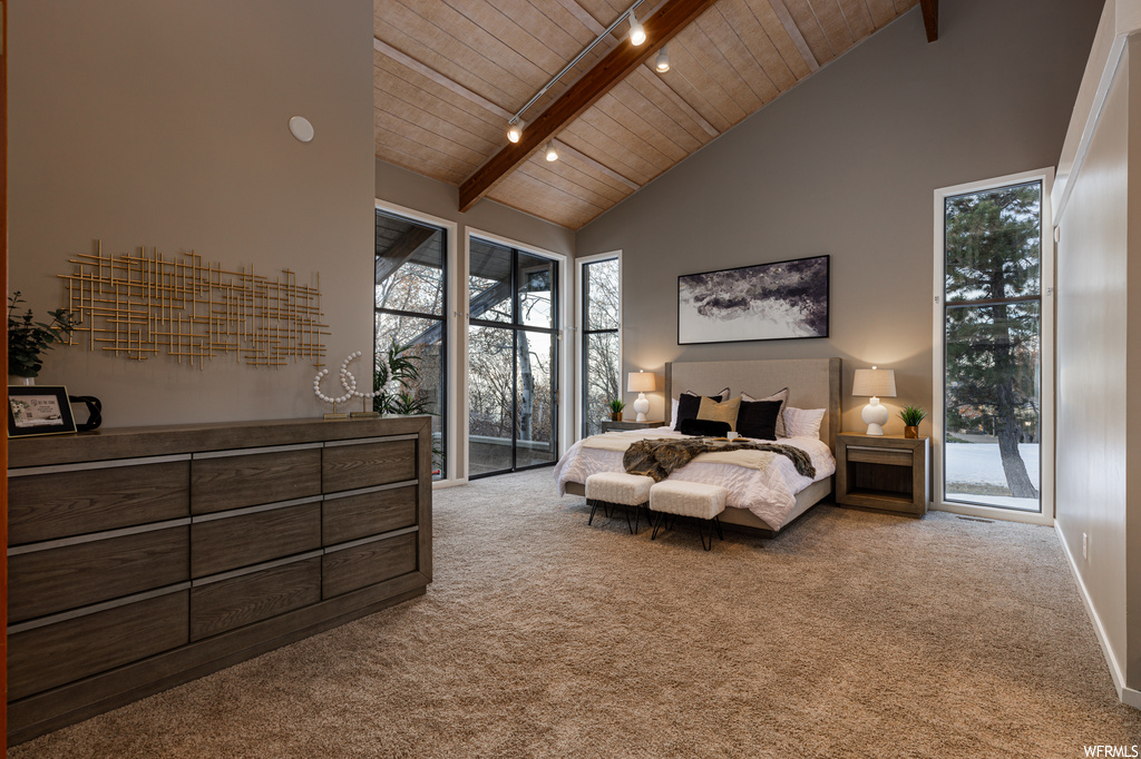 Bedroom with wood ceiling, high vaulted ceiling, access to exterior, and beamed ceiling